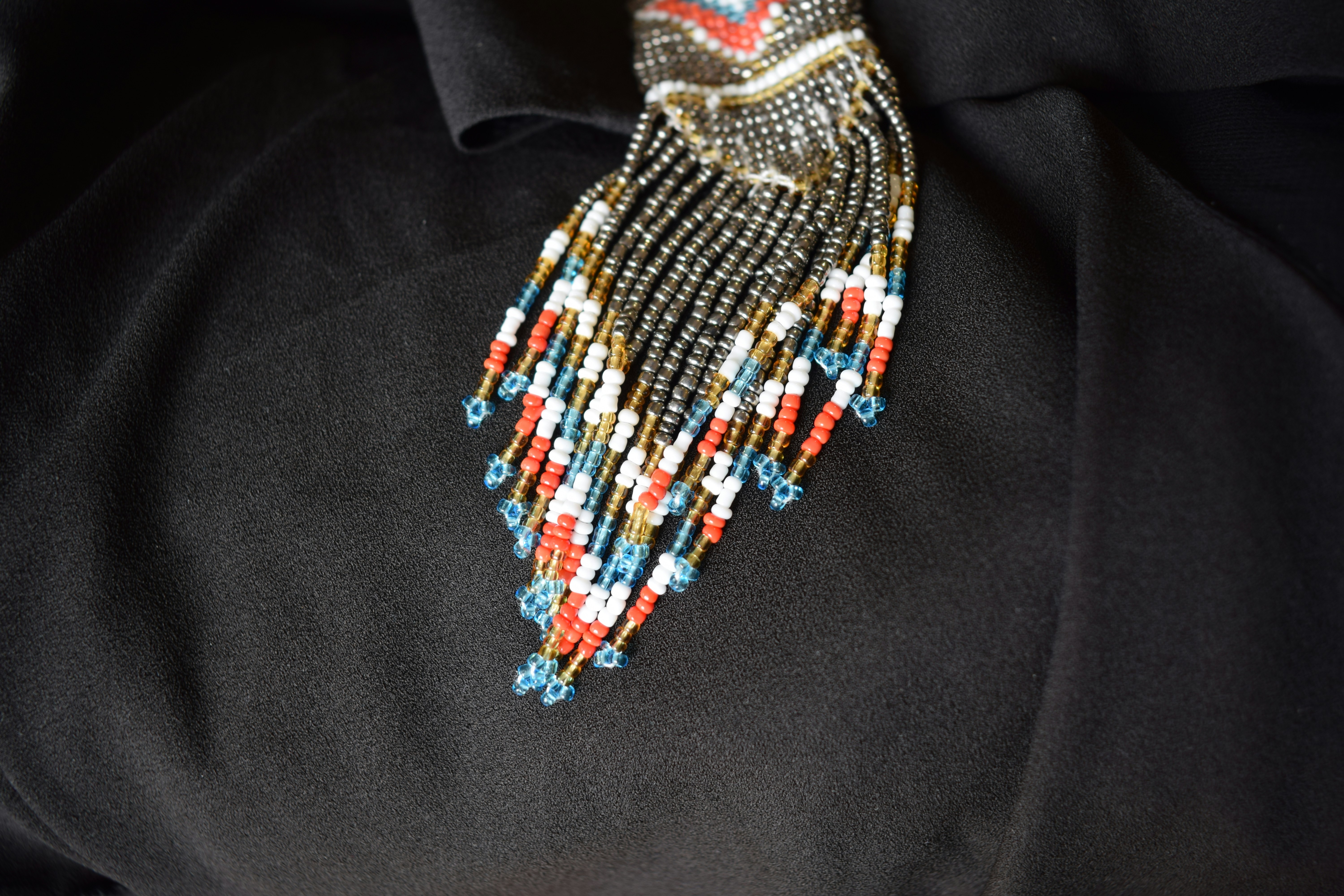 a close up of a tie with beads on it