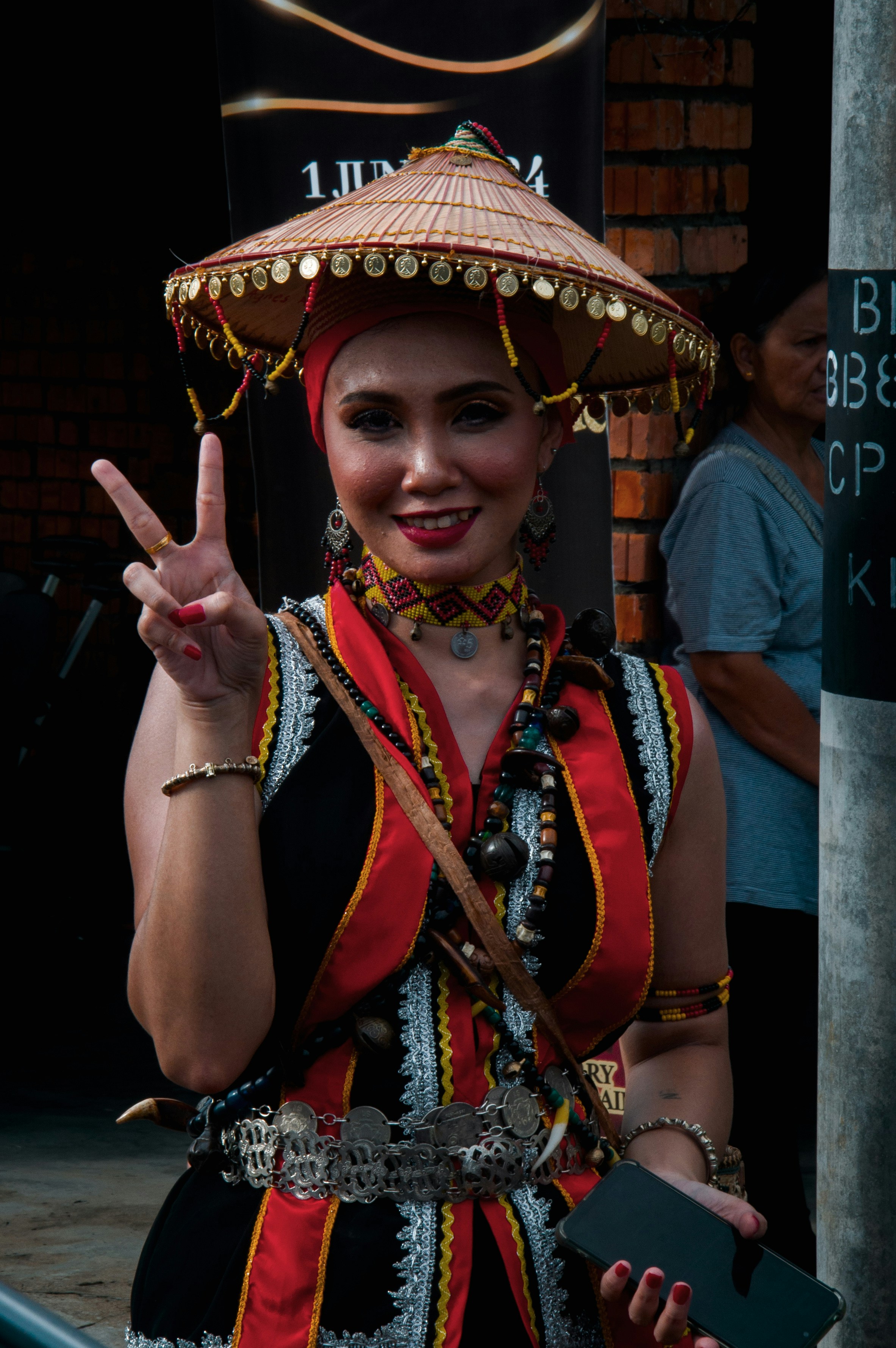 a woman wearing a sombrero making a peace sign