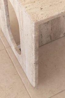a close up of a marble table on a tile floor