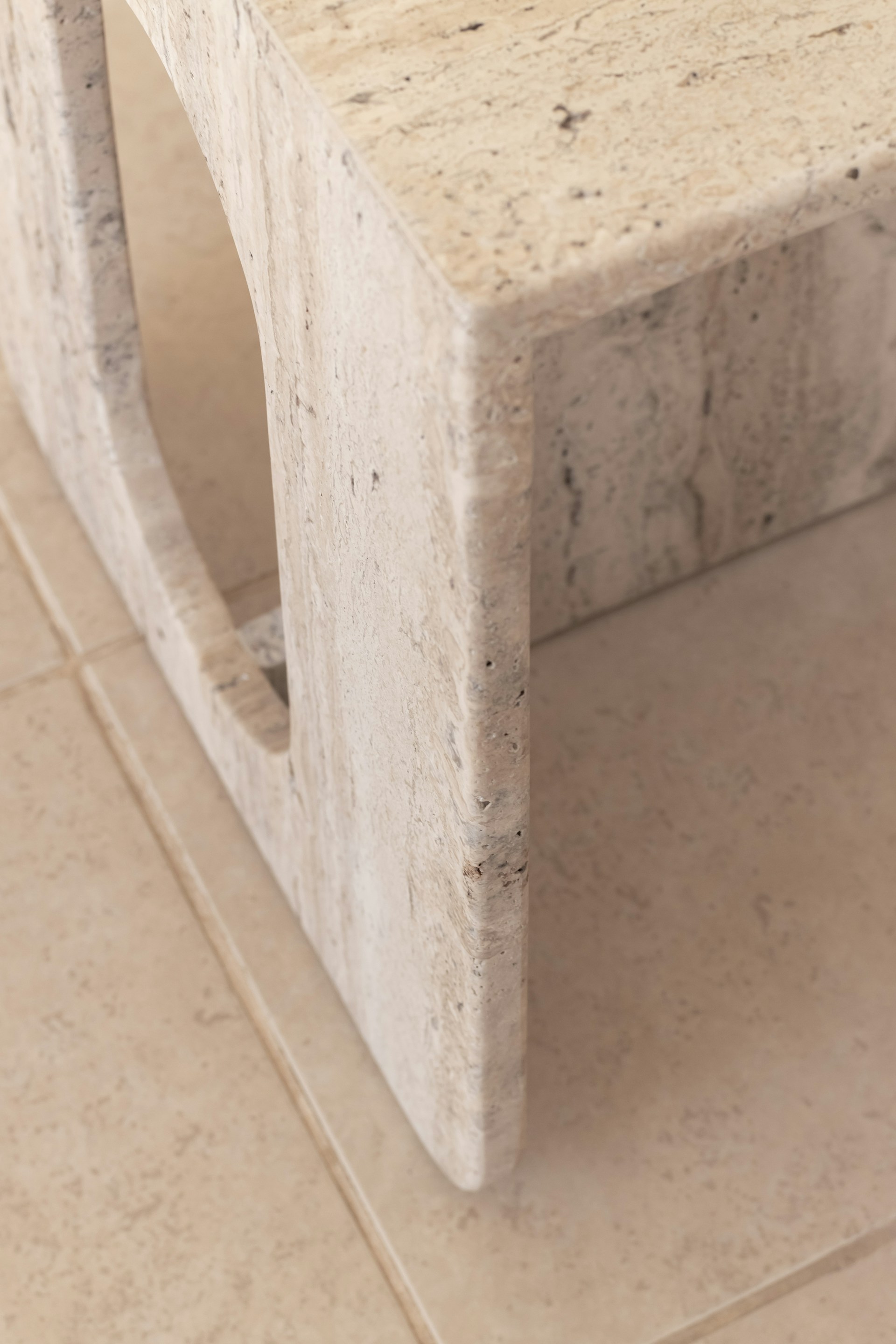 a close up of a marble table on a tile floor