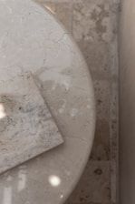 a close up of a marble table with a square object on it