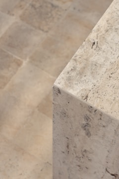 a close up of a marble bench on a tiled floor