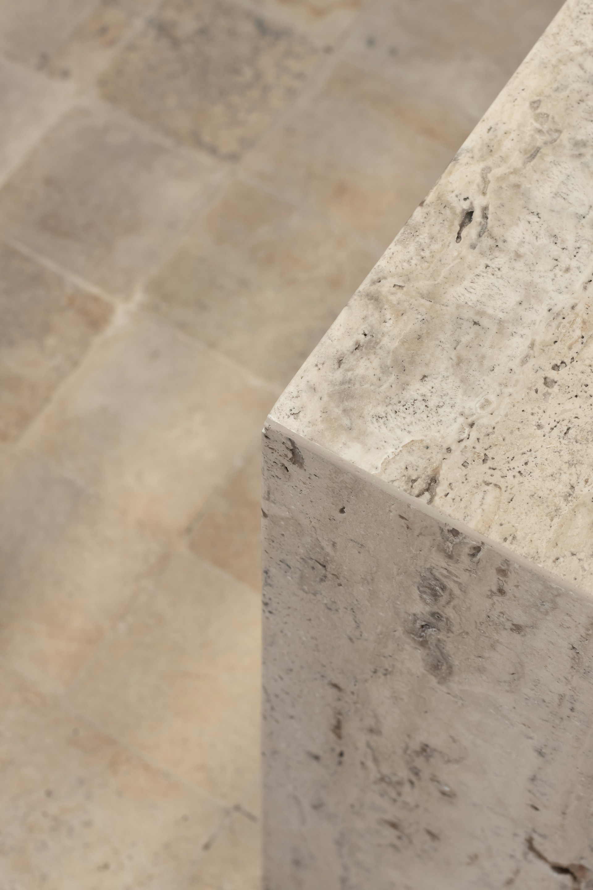 a close up of a marble bench on a tiled floor