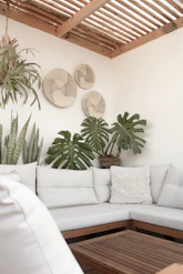 a white couch sitting under a wooden ceiling