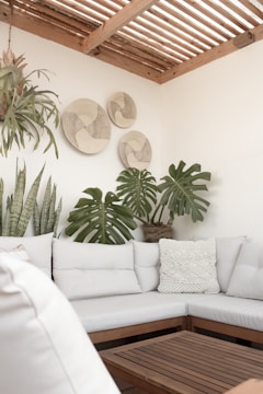 a white couch sitting under a wooden ceiling