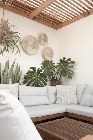 a white couch sitting under a wooden ceiling