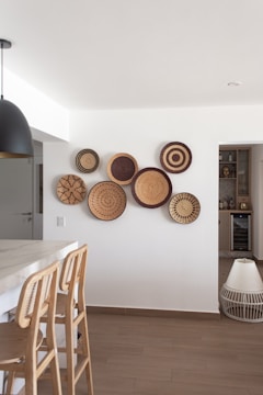 a kitchen area with a table and chairs