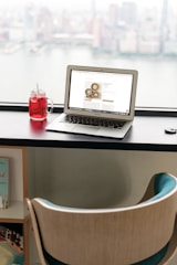 a laptop computer sitting on top of a wooden desk