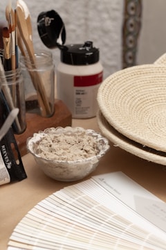 a wooden table topped with a bowl of food