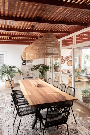 a large wooden table surrounded by black chairs