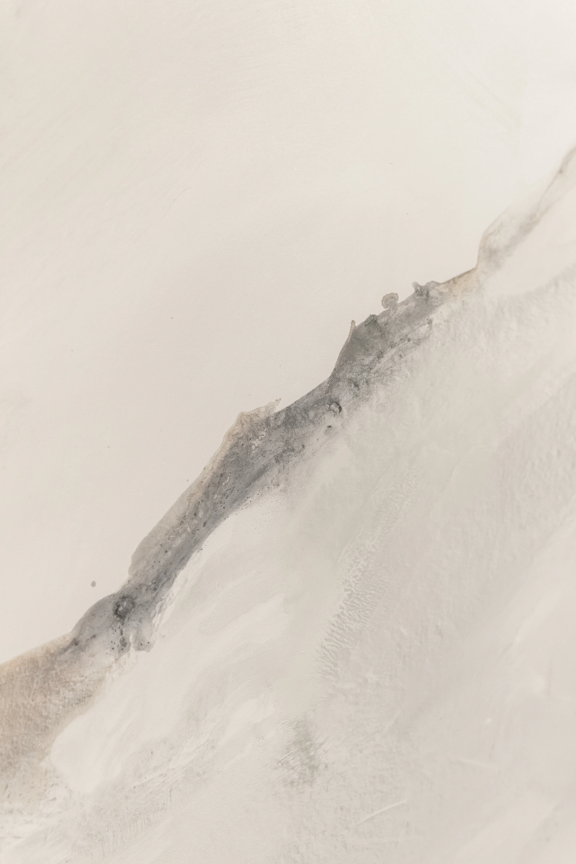 a man riding a snowboard down a snow covered slope