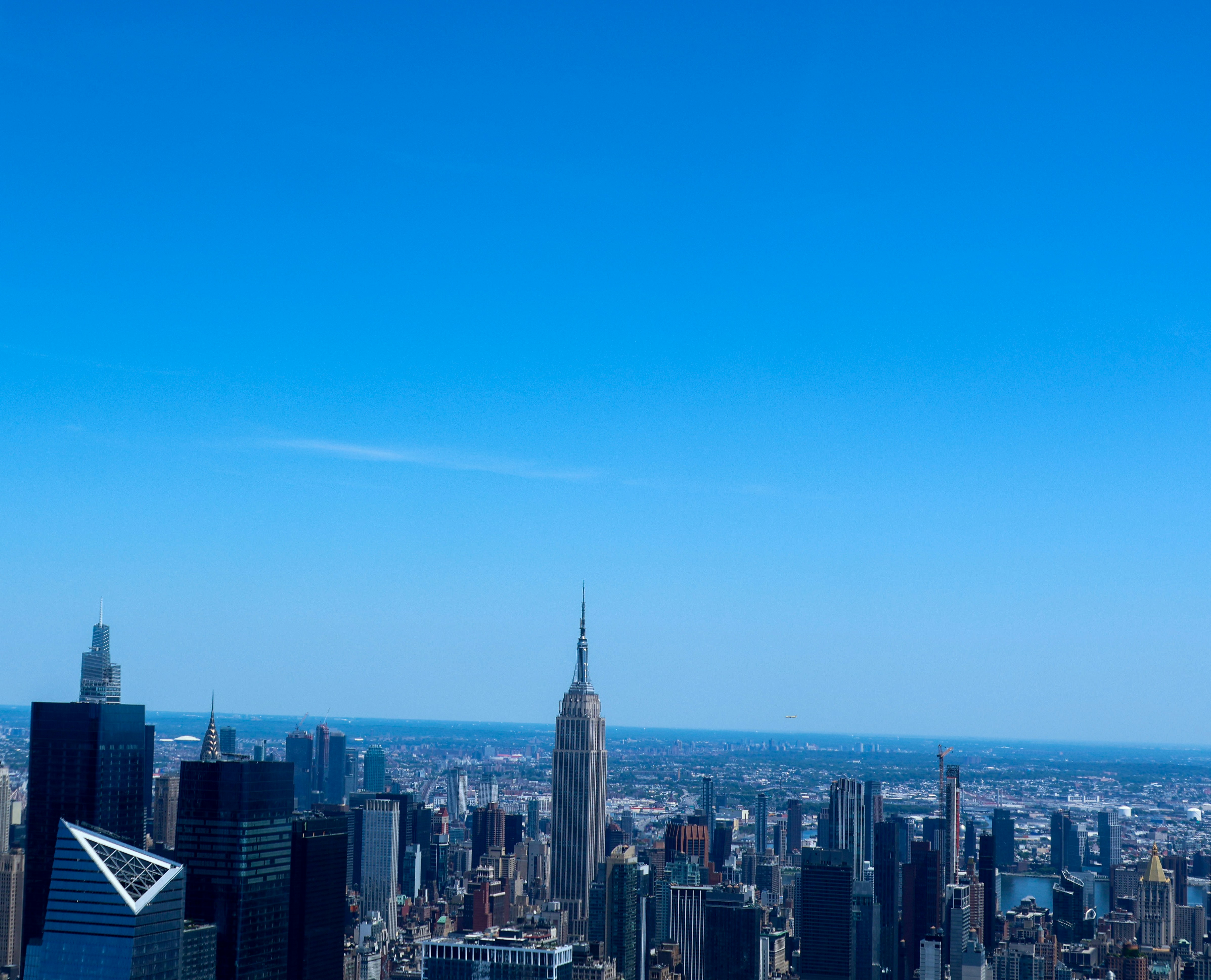 a view of a city from the top of a building, View of NYC skyline by helicopter