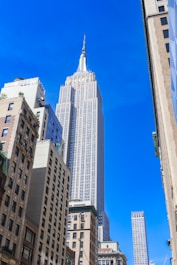 a tall building towering over a city filled with tall buildings
