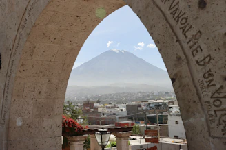 a view of a mountain through an arch