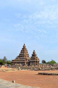 a large stone structure sitting on top of a dirt field