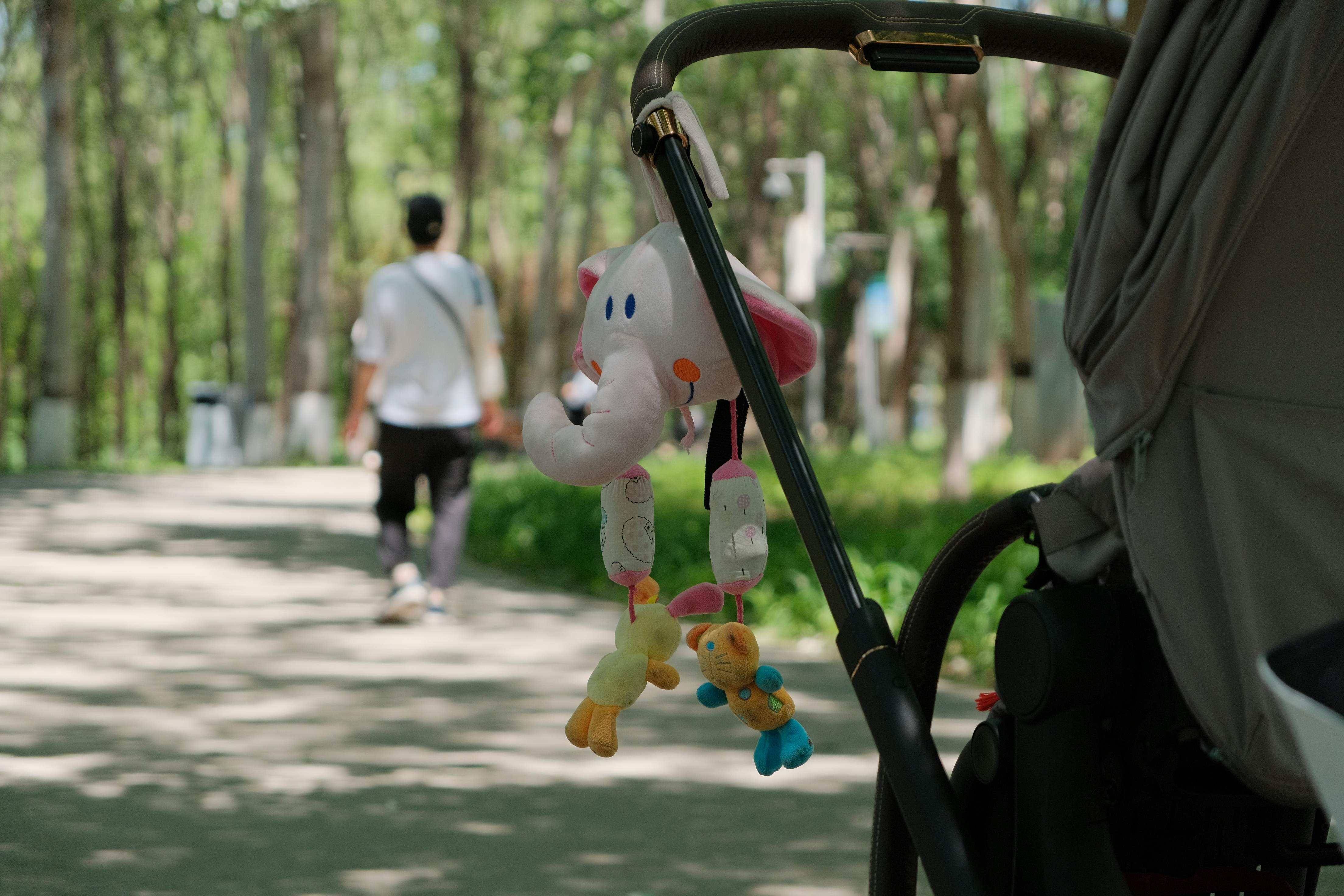 a stroller with a stuffed animal hanging from it's handle