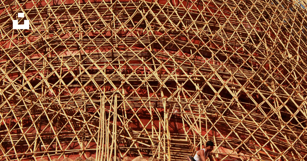 Structure With Sticks A large structure made of sticks on top of a building photo – Free ...