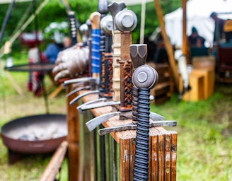 a row of different types of tools on a wooden fence