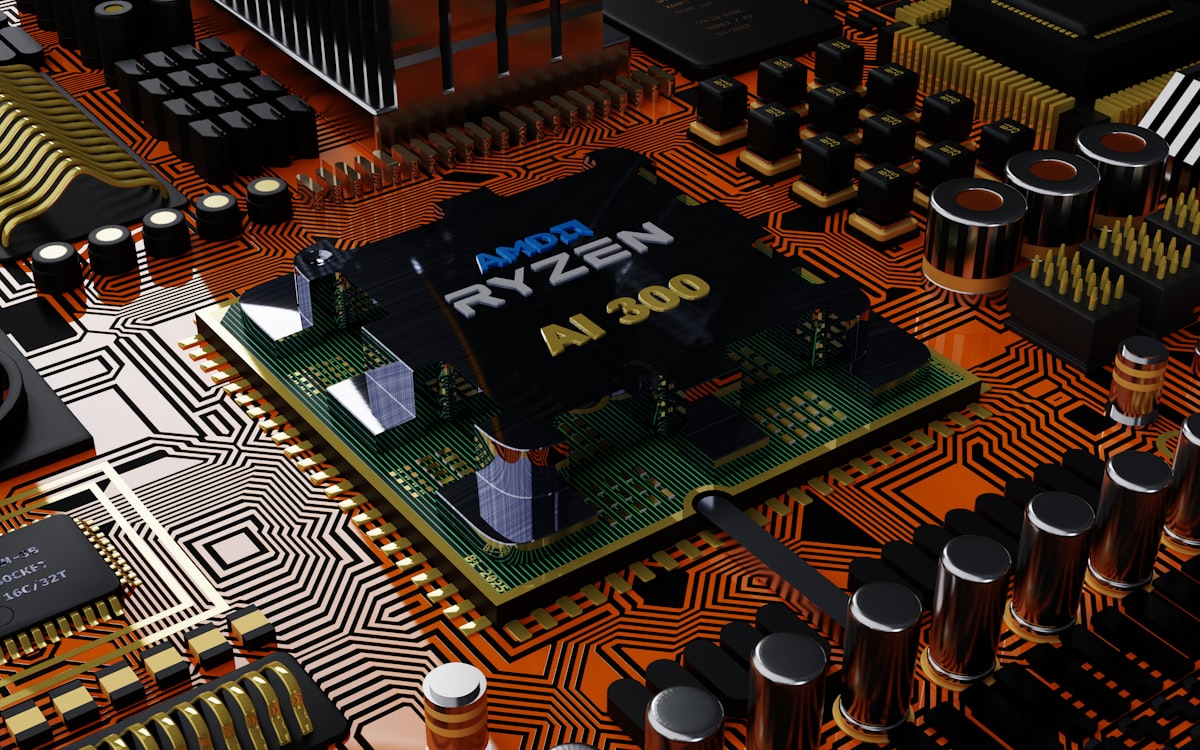 AI processor chip with orange circuit traces on dark board