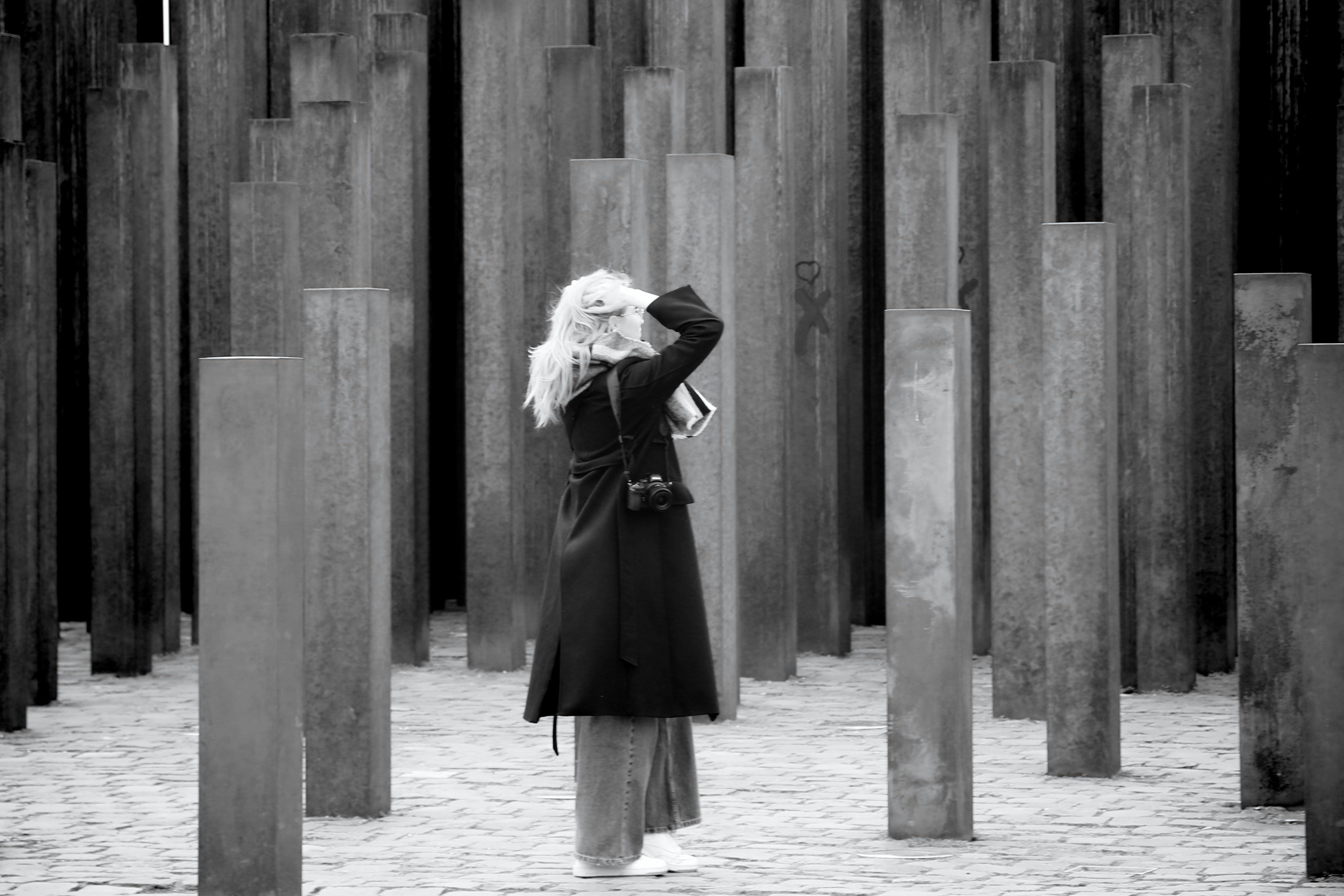 a woman standing in front of a bunch of poles