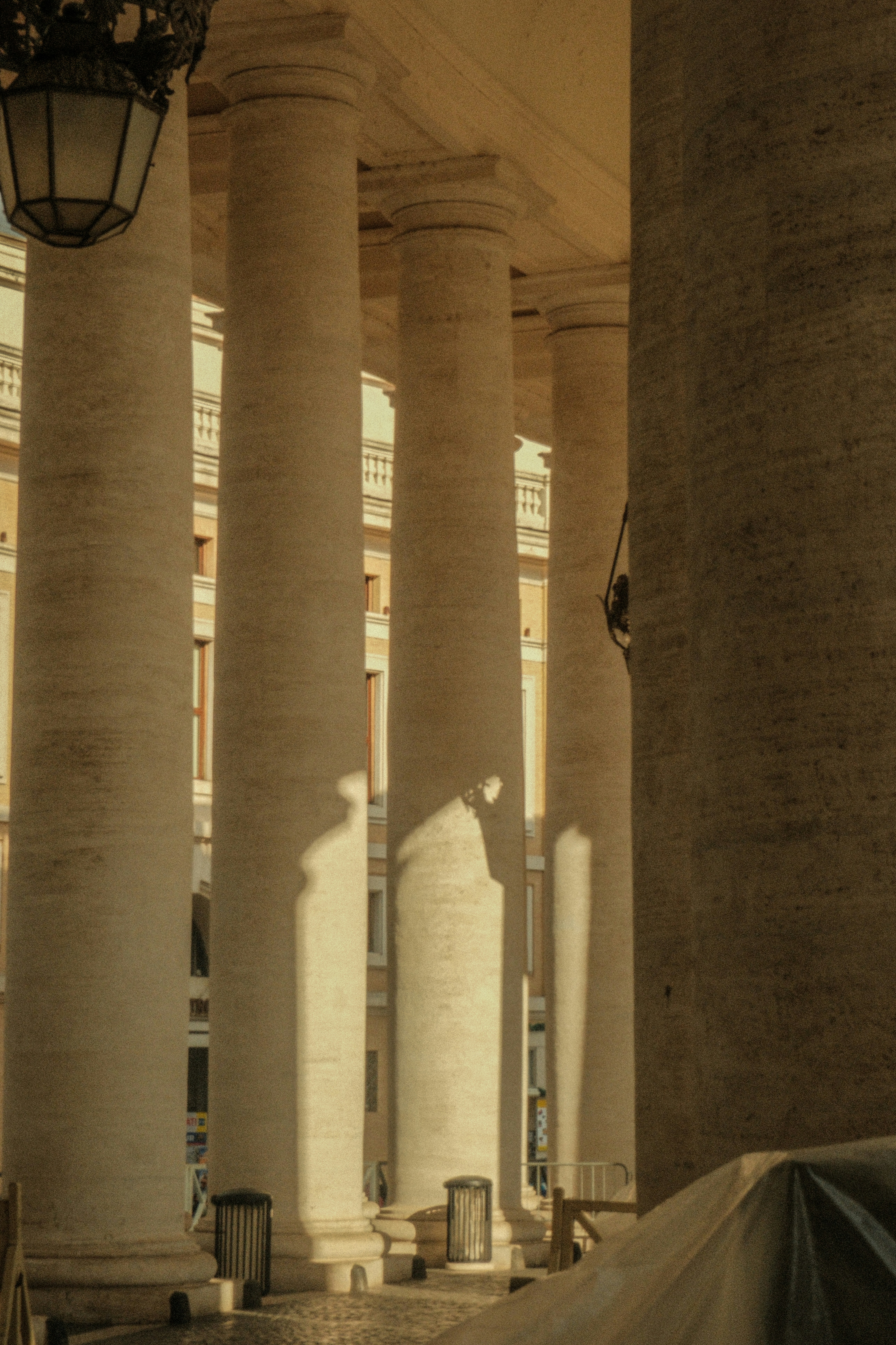 a row of white pillars in front of a building