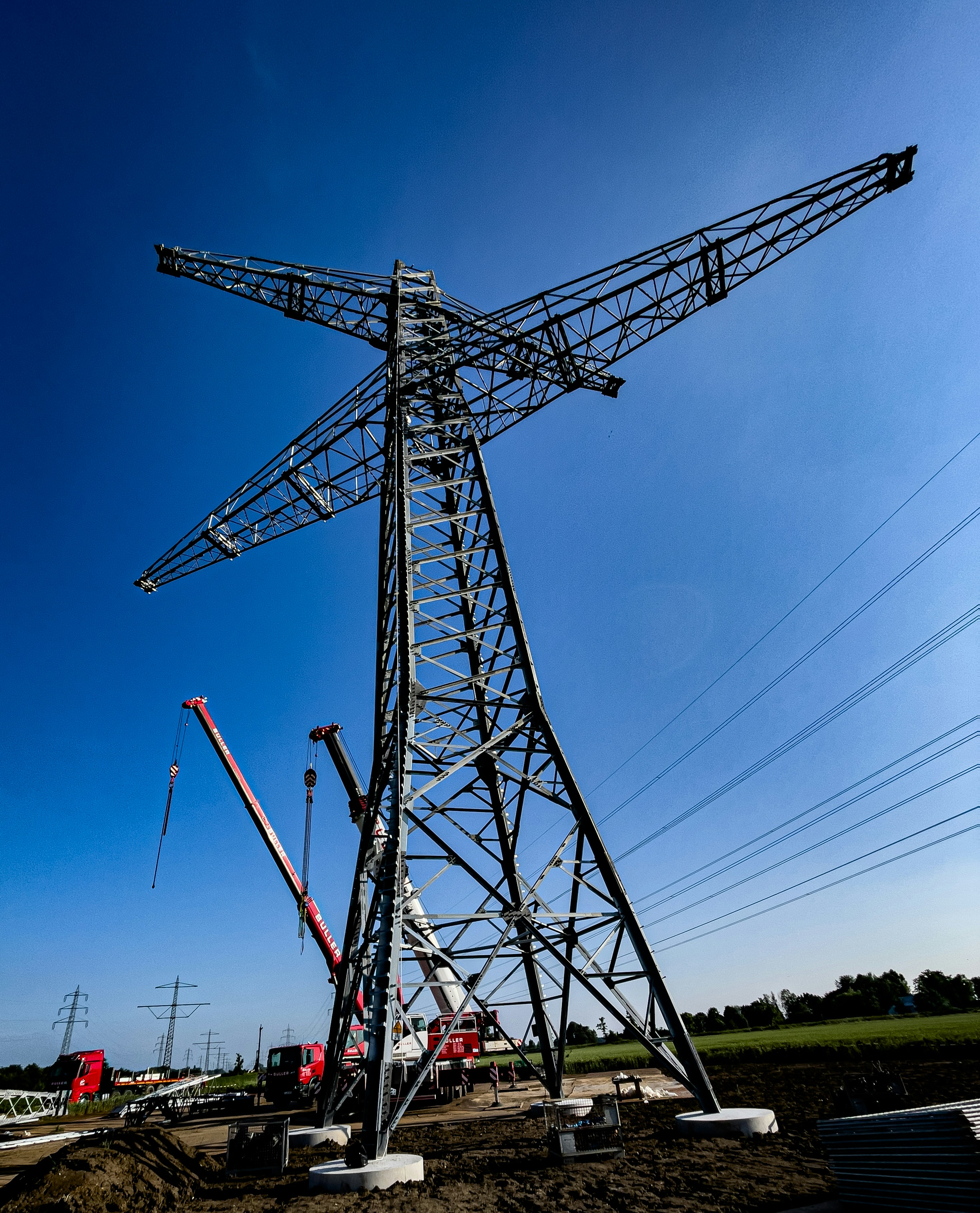 a large metal tower sitting on top of a dirt field