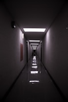 a long hallway with a light at the end of it
