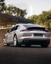 a silver sports car parked in front of a building