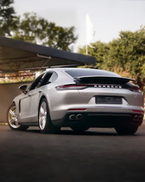 a silver sports car parked in front of a building