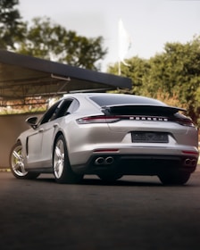 a silver sports car parked in front of a building