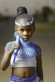 a young girl wearing a blue and white costume