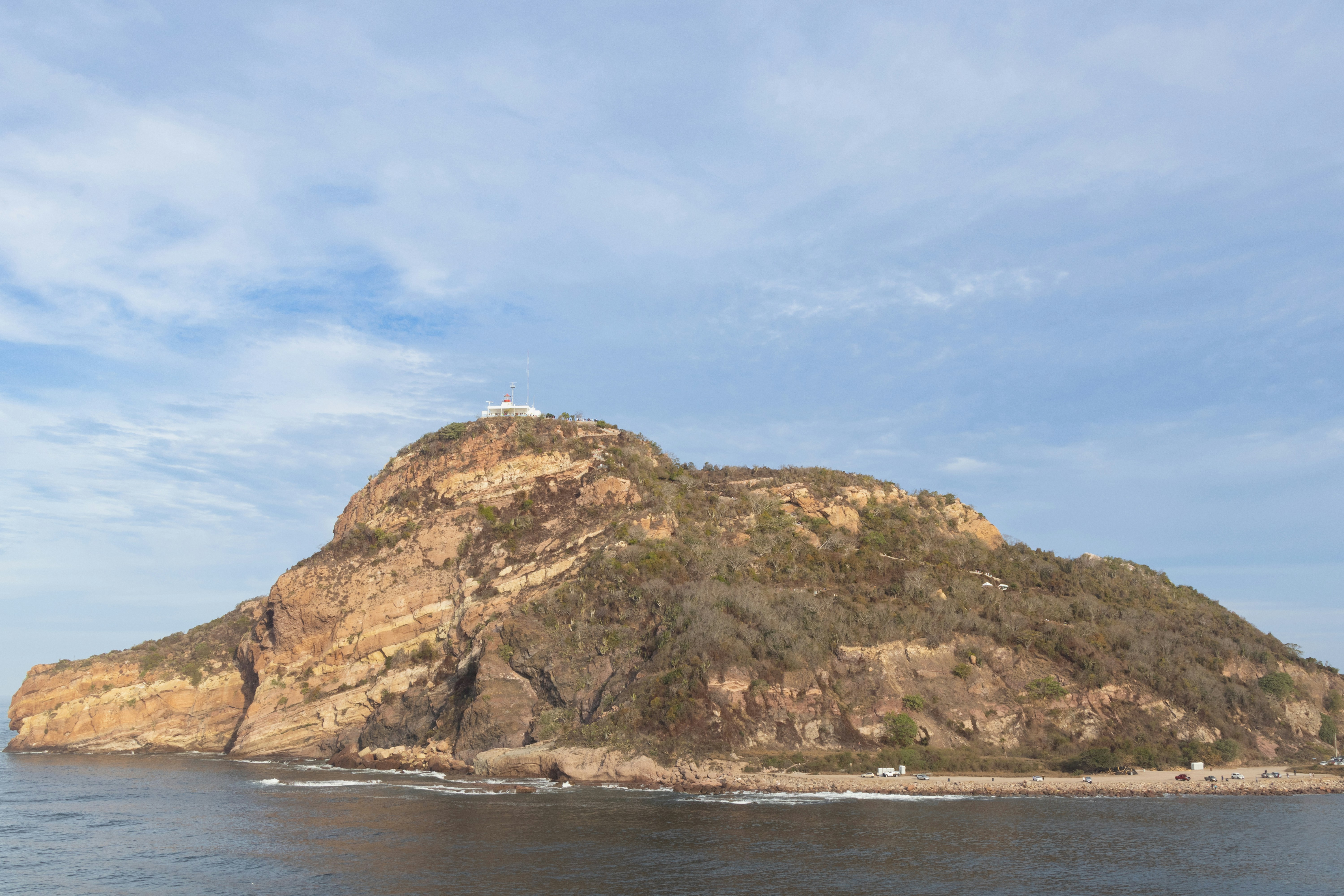 a small island in the middle of a body of water, 