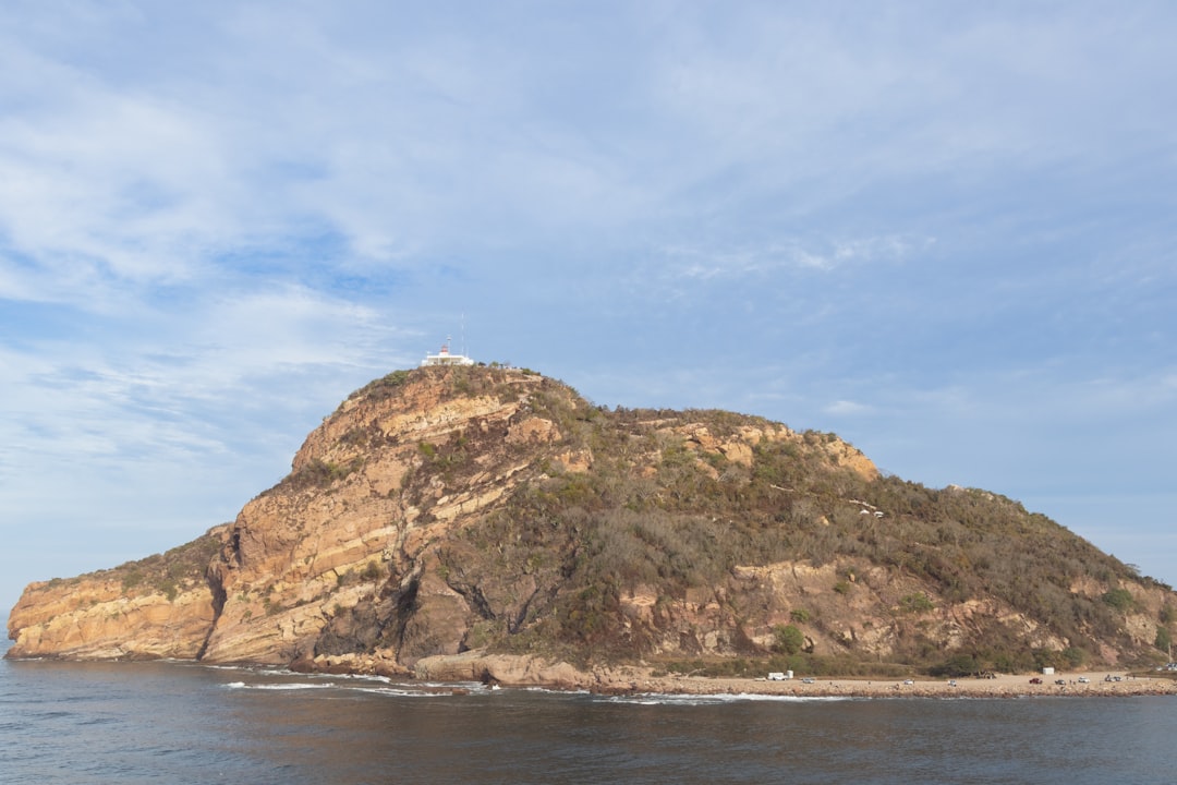 a small island in the middle of a body of water,