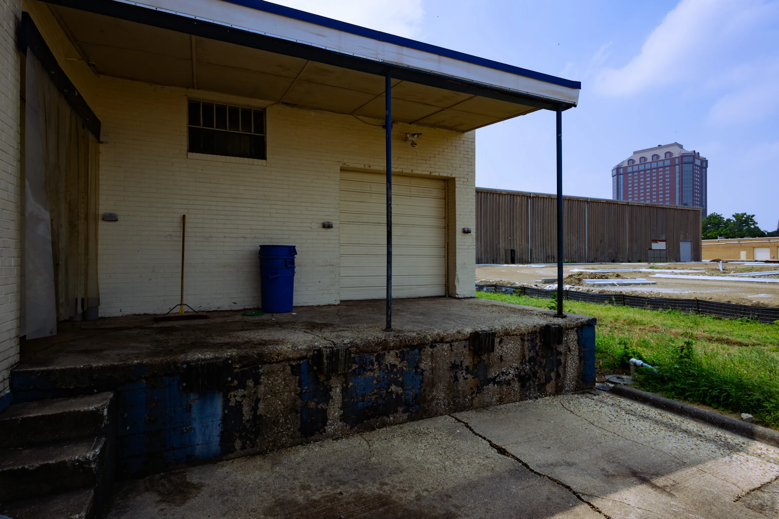 A plain white building exterior in flat daylight