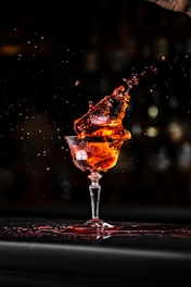 a glass filled with liquid sitting on top of a table