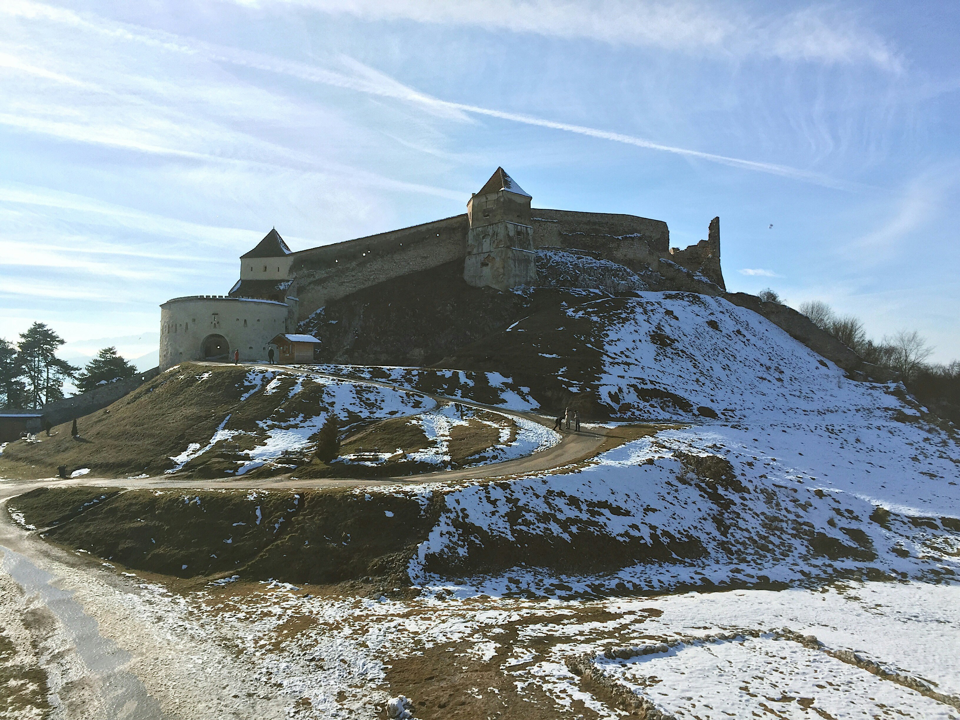 a castle sitting on top of a snow covered hill