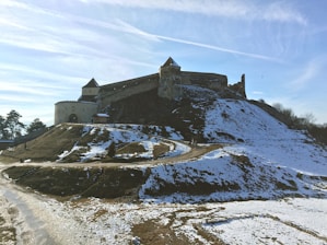 a castle sitting on top of a snow covered hill
