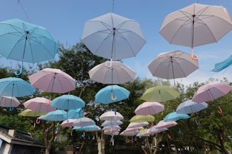 a bunch of umbrellas that are hanging in the air