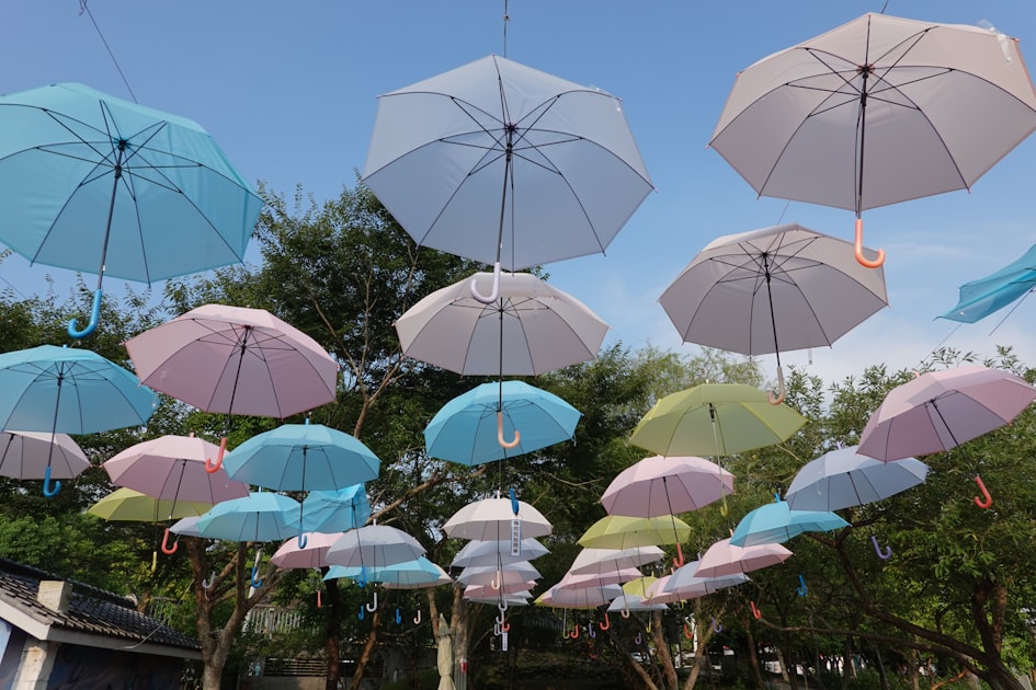 a bunch of umbrellas that are hanging in the air