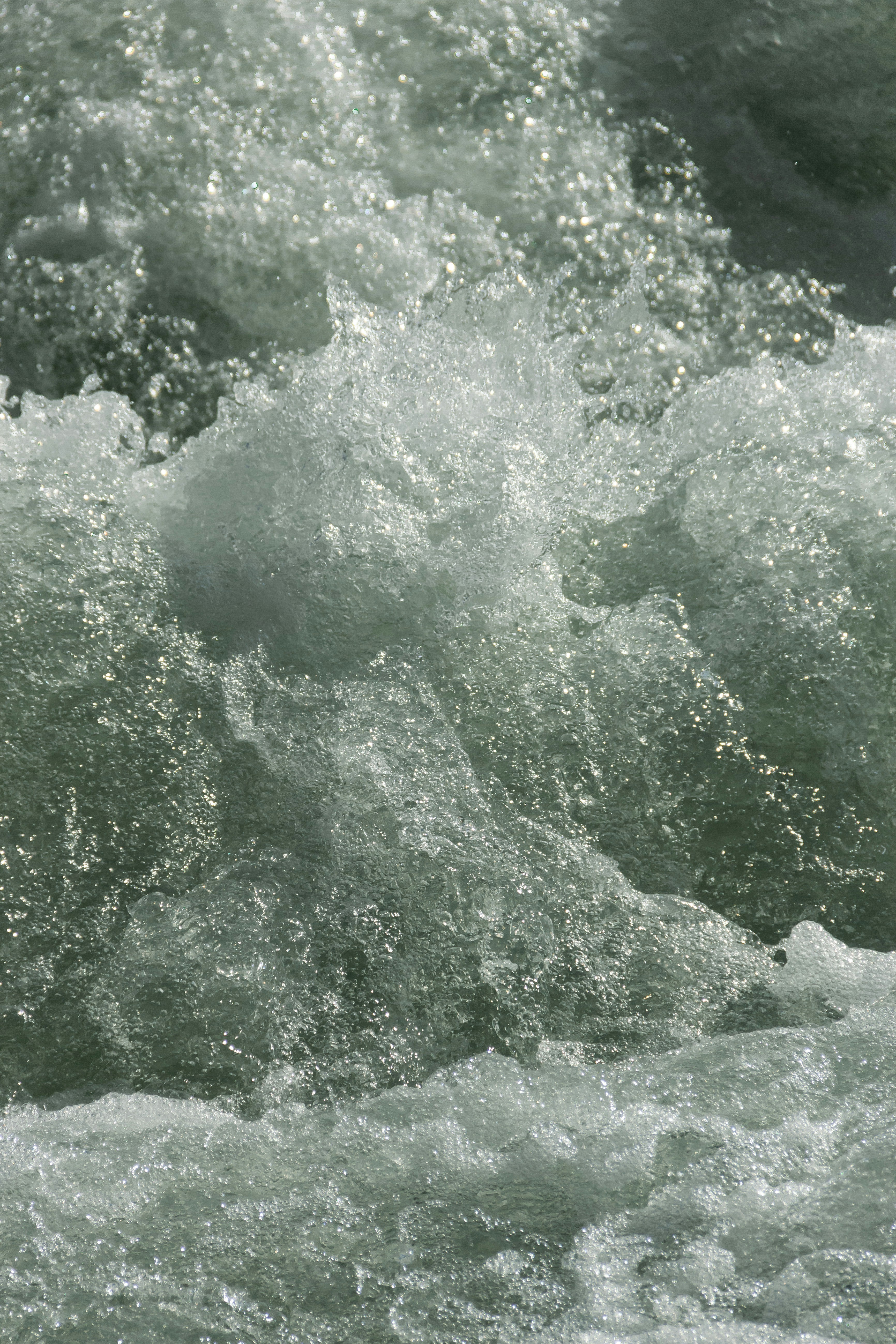 a man riding a surfboard on top of a wave