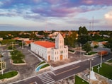 an aerial view of a church in a small town