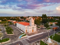 an aerial view of a church in a small town