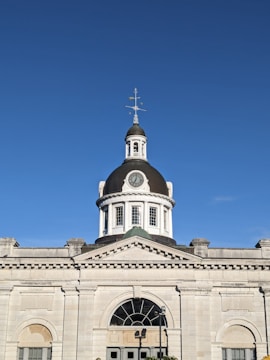 a tall building with a cross on top of it