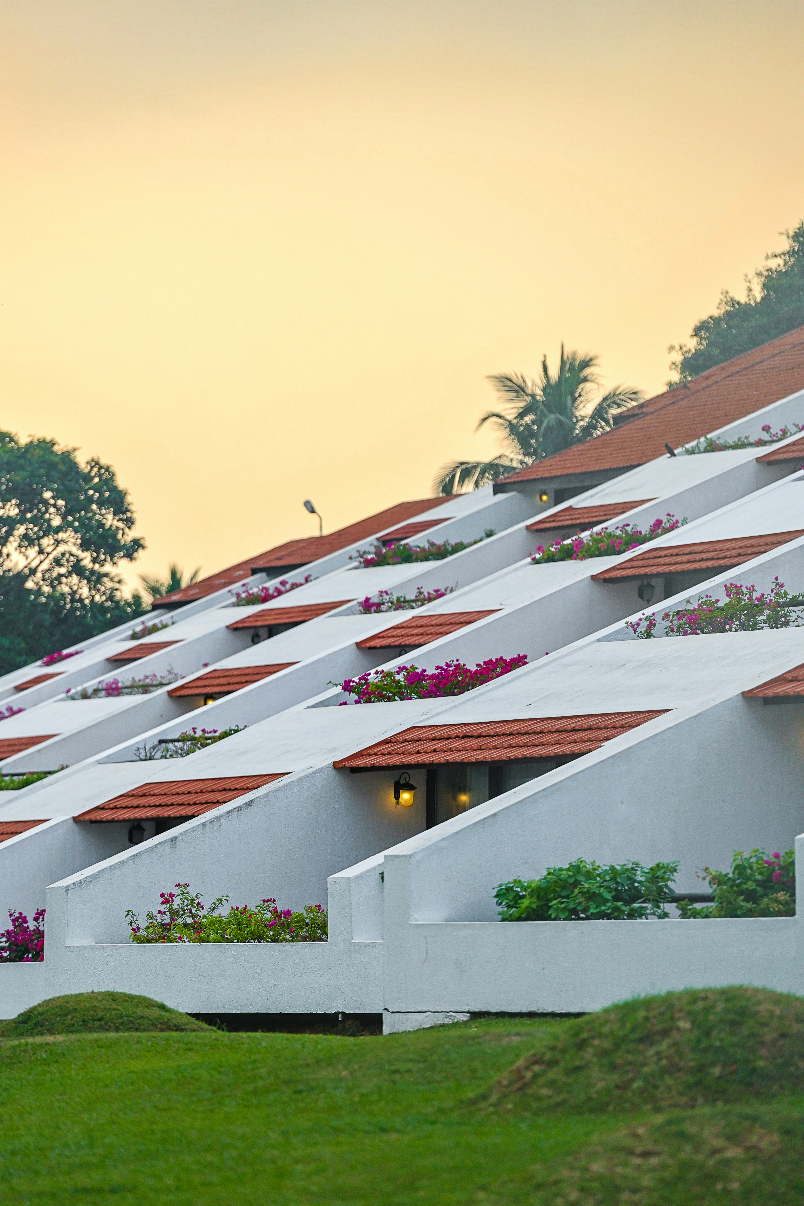 a row of white buildings with red roof tops