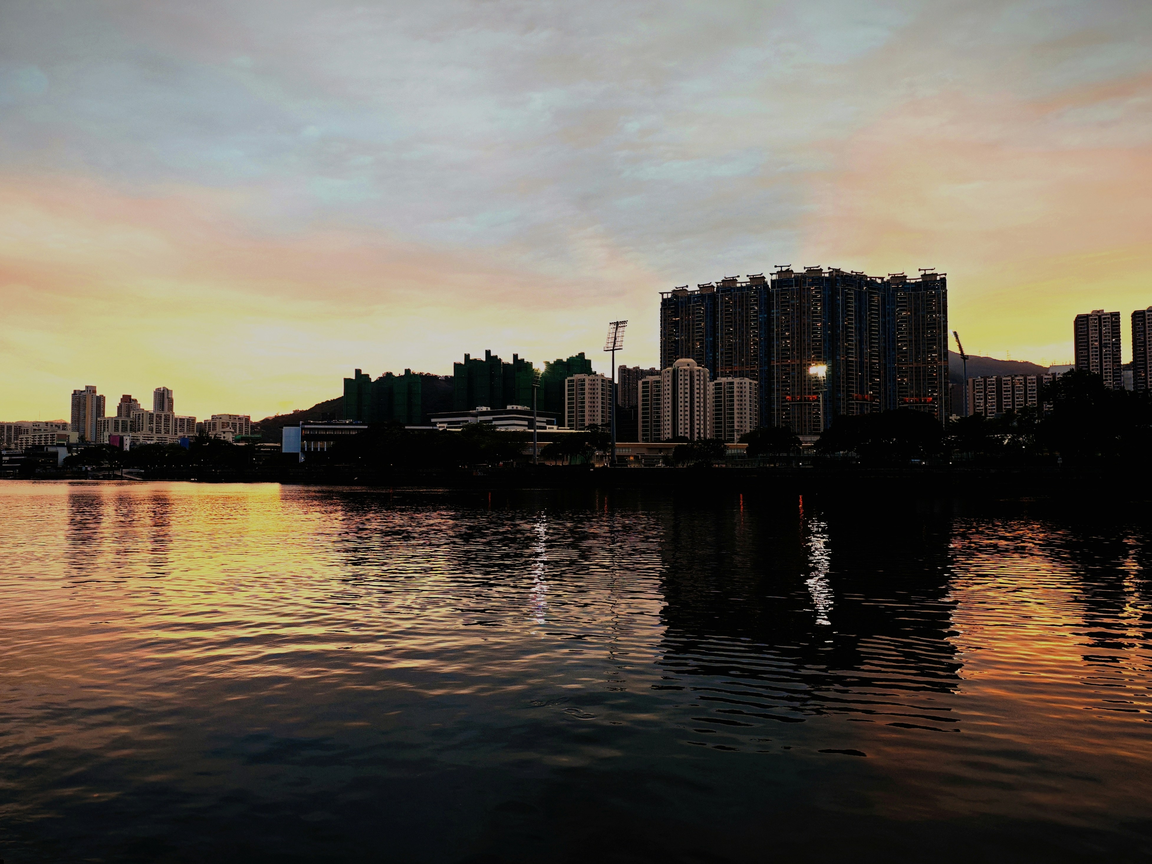 a large body of water with a city in the background