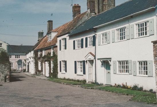 a row of white houses on a cobblestone street