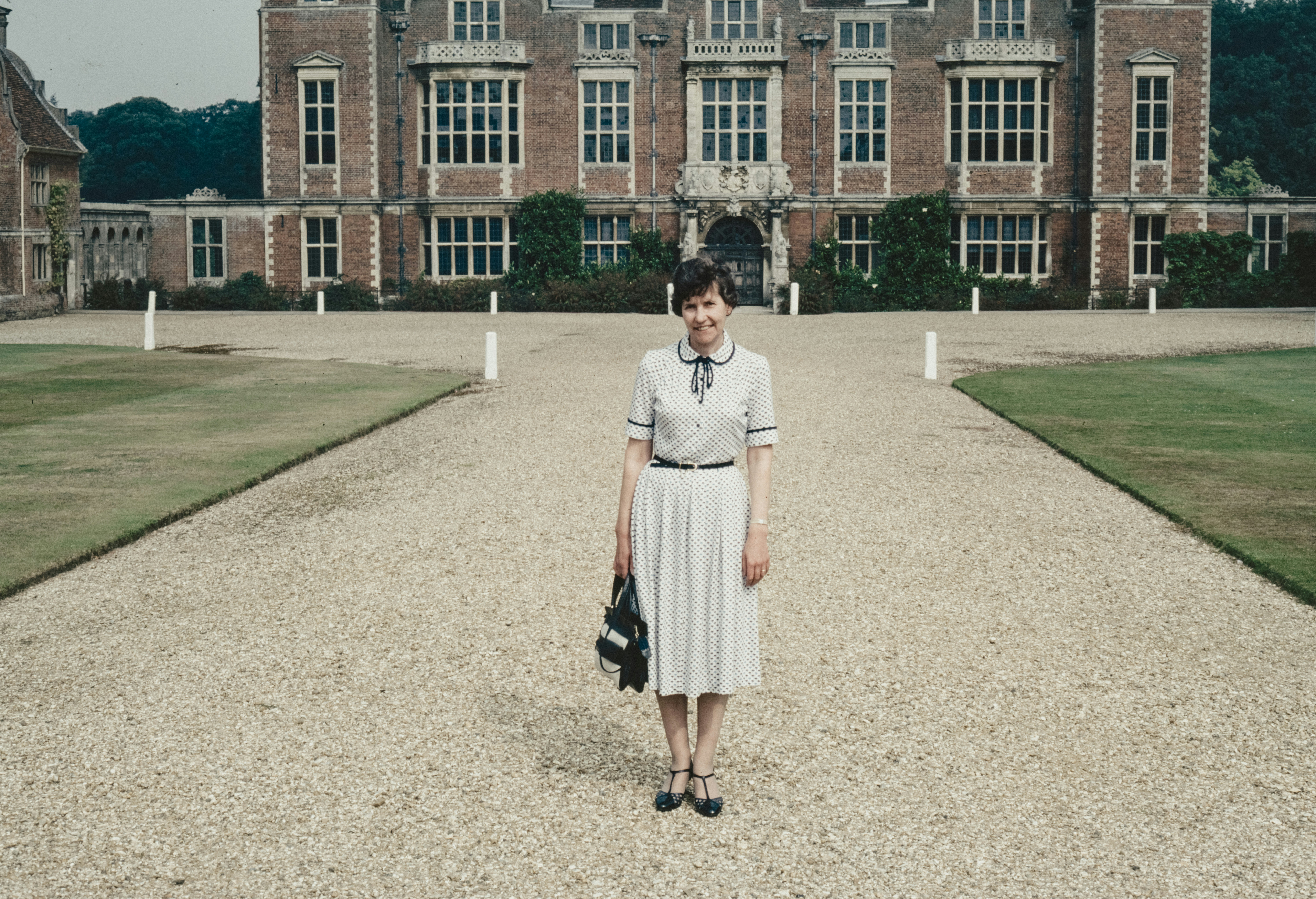 a woman standing in front of a large building