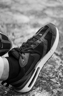 a black and white photo of a person's shoes