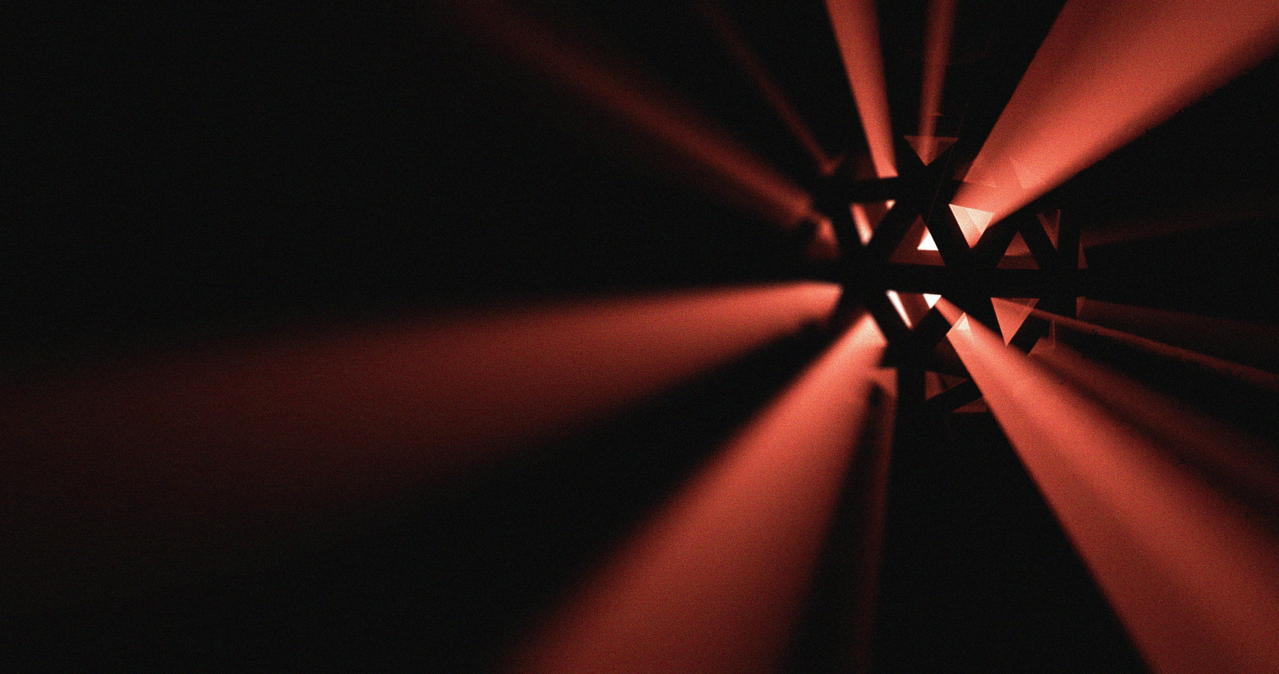 a red light shining through a dark room