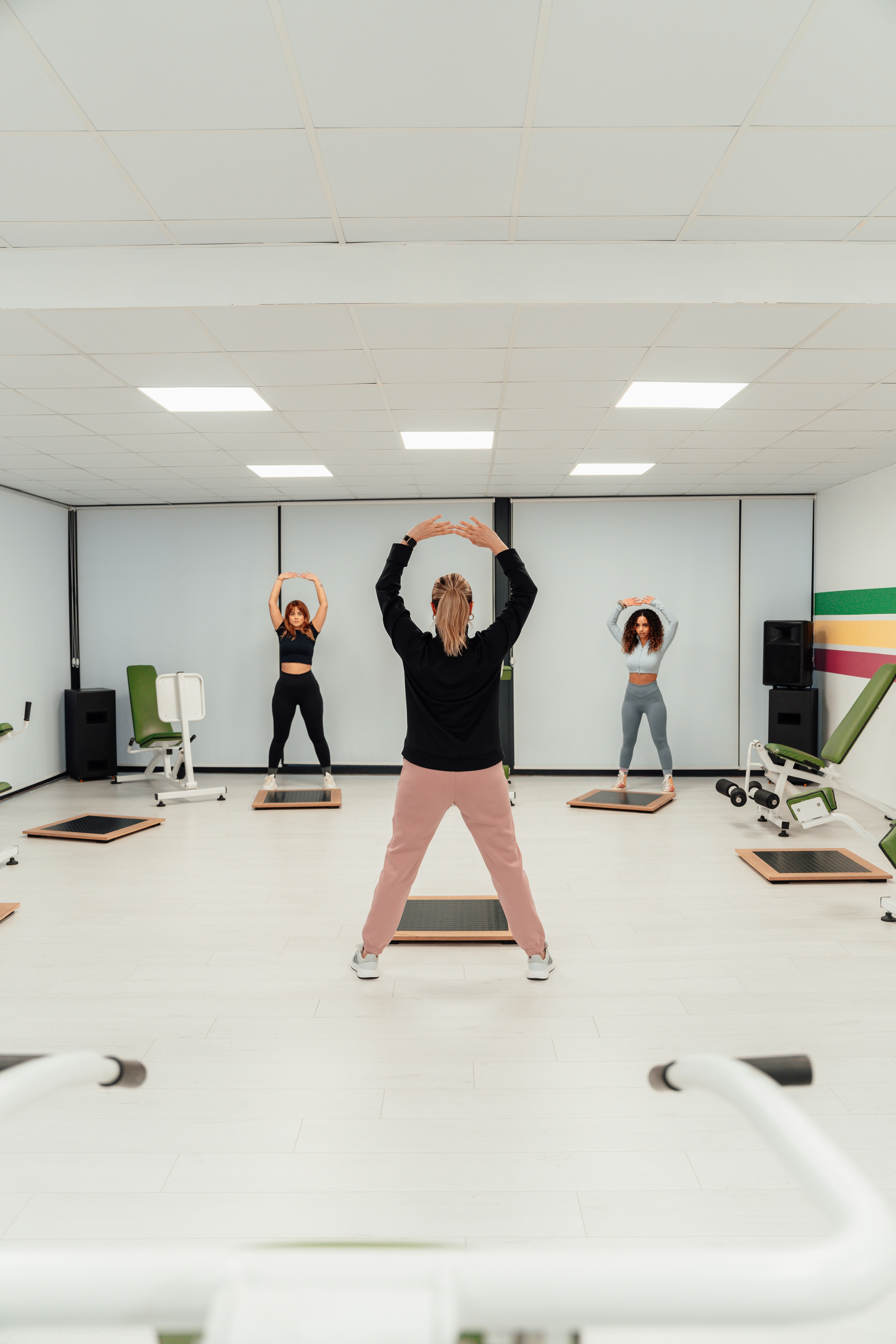 a group of people in a room doing yoga
